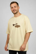 Man wearing a beige t-shirt with a graphic design on a gray background