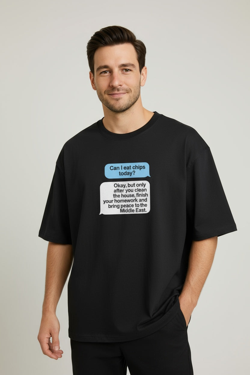 Man wearing a black t-shirt with text graphics on a plain background