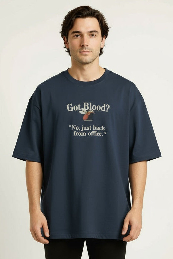 Person wearing a navy blue t-shirt with humorous text design on a plain background