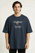 Person wearing a navy blue t-shirt with humorous text design on a plain background